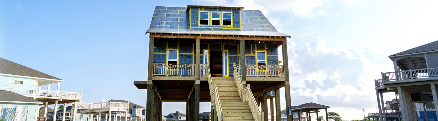 Cape Cod-style house on pilings sheathed in ForceField® Weather Barrier System. 