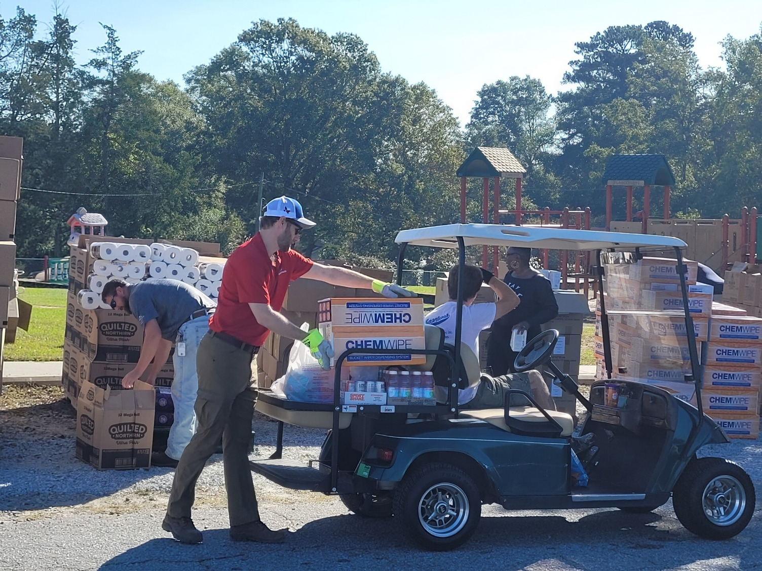 Georgia-Pacific employee loading supplies in a golf cart.